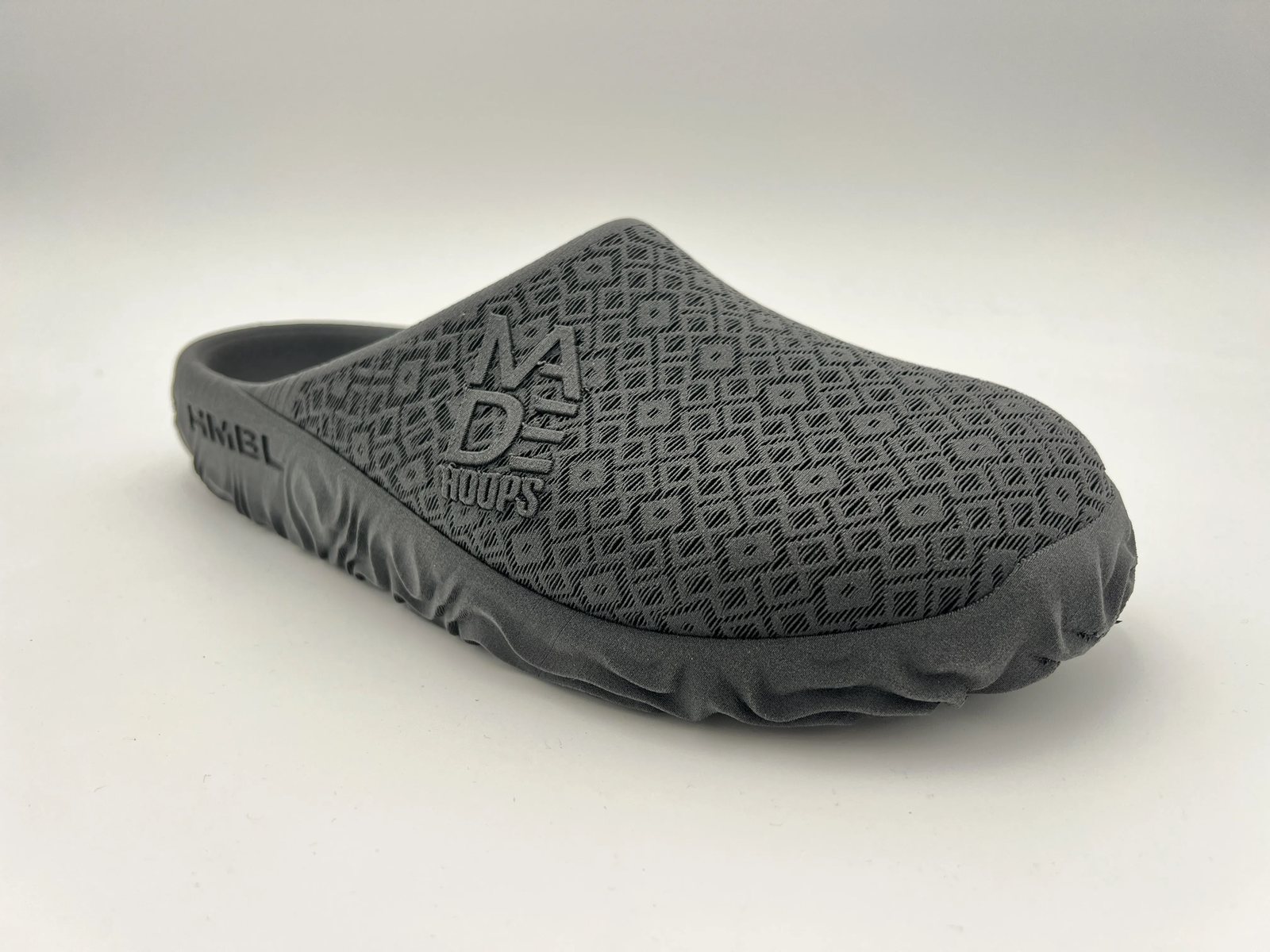 A customer pair, lateral three-quarter view, with a raised mark on the upper and a cut mark in the sidewall